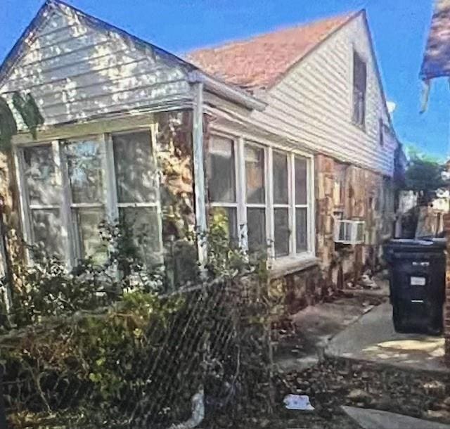 view of side of property featuring a sunroom