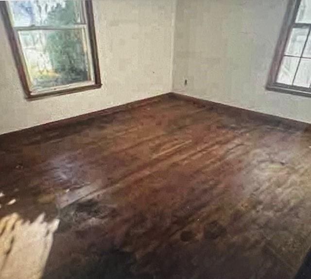 unfurnished room with dark hardwood / wood-style floors