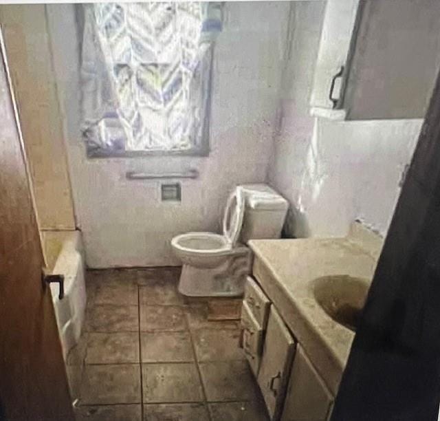 bathroom with tile patterned flooring, vanity, tile walls, and toilet