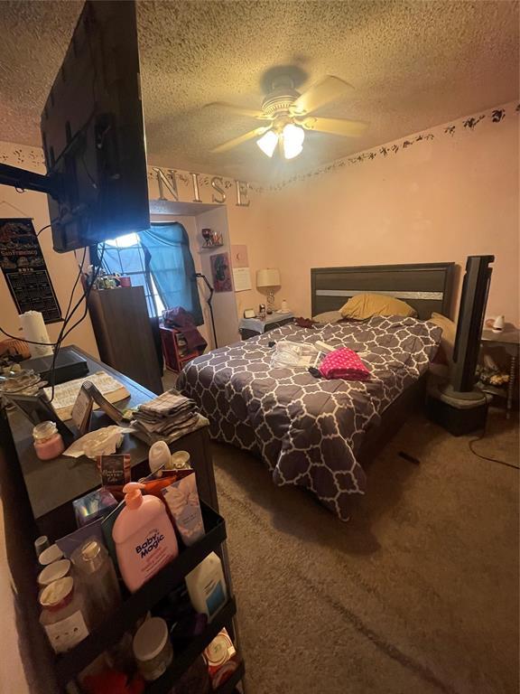 bedroom featuring carpet floors and a textured ceiling