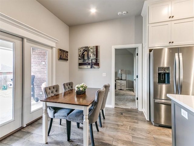 dining space featuring french doors and light wood-type flooring