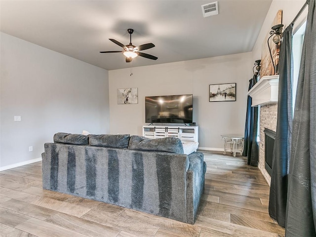 living room featuring ceiling fan and light wood-type flooring