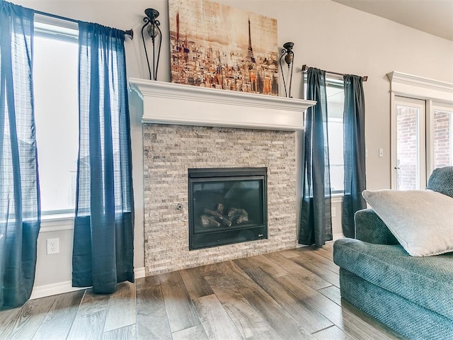 living area with hardwood / wood-style flooring and a fireplace