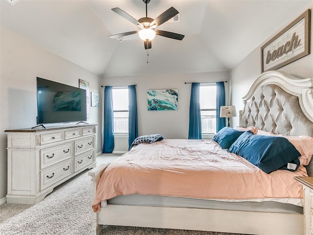 bedroom with light carpet, vaulted ceiling, and multiple windows