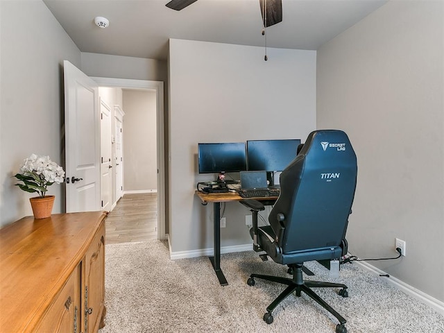 office area with light hardwood / wood-style floors and ceiling fan