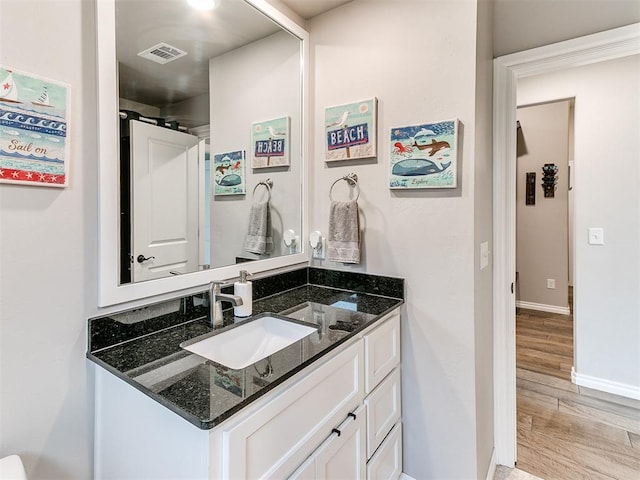 bathroom with vanity and hardwood / wood-style flooring