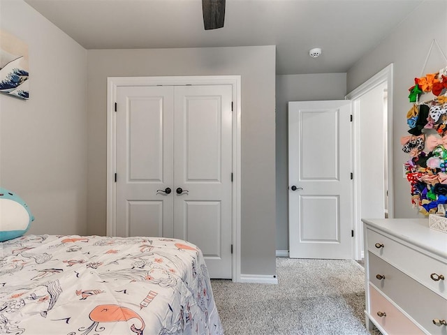 carpeted bedroom featuring ceiling fan and a closet