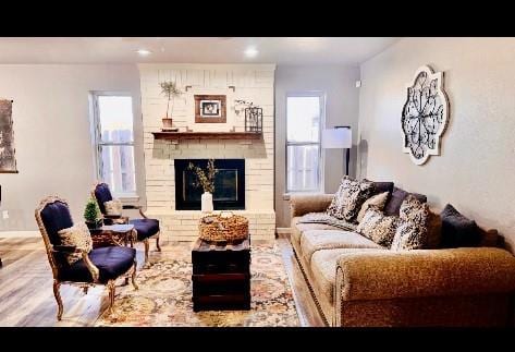 living room with a large fireplace and plenty of natural light