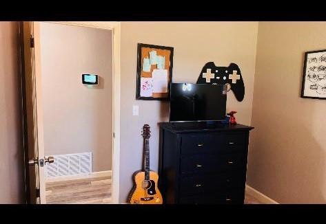 bedroom featuring hardwood / wood-style flooring