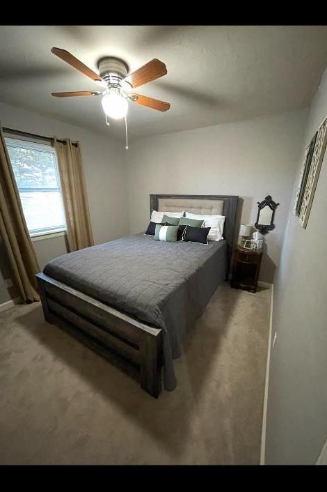 carpeted bedroom featuring ceiling fan