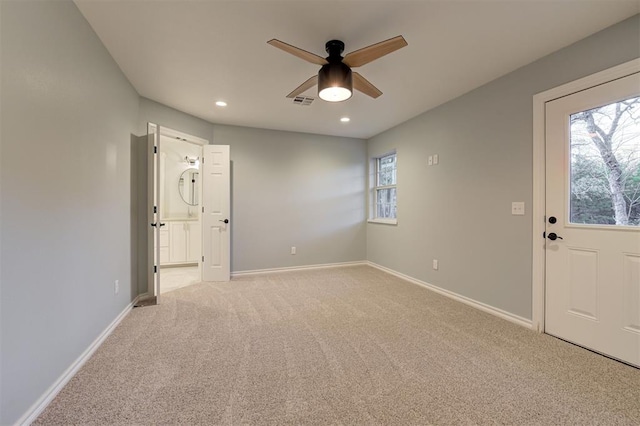 carpeted empty room featuring ceiling fan