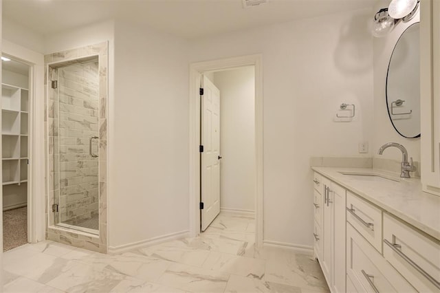 bathroom with vanity and a shower with door