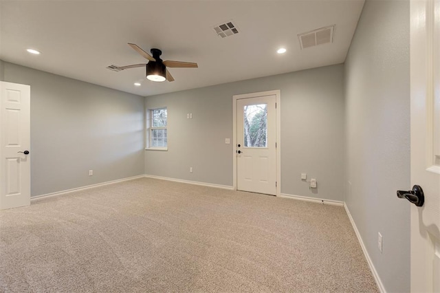 carpeted empty room featuring ceiling fan