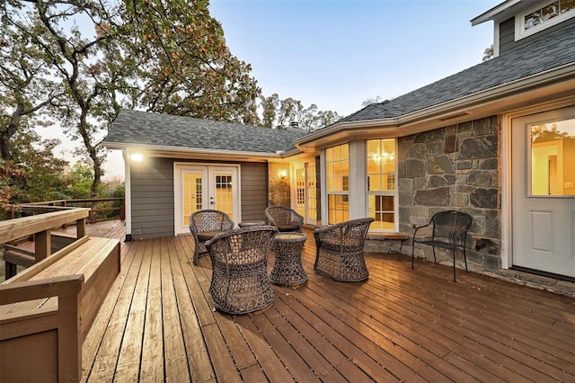 deck at dusk featuring french doors