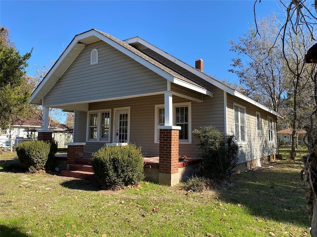 bungalow-style house featuring a porch and a front lawn