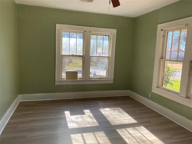 empty room with hardwood / wood-style flooring and ceiling fan