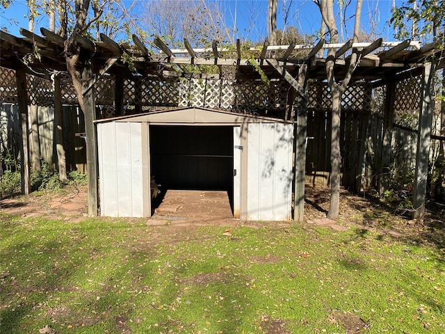 view of outbuilding featuring a pergola and a yard