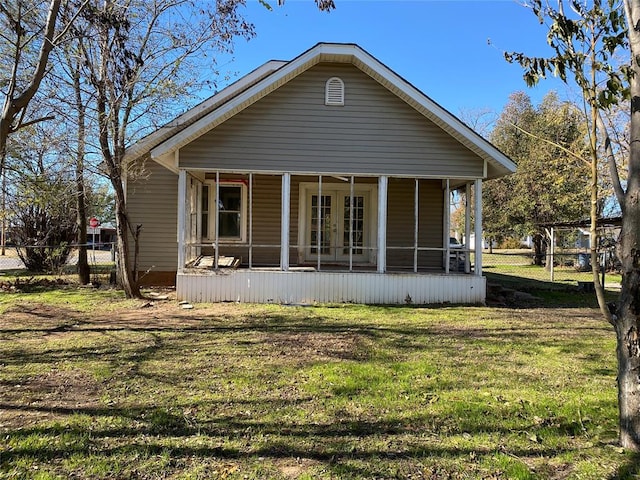 rear view of property featuring a yard