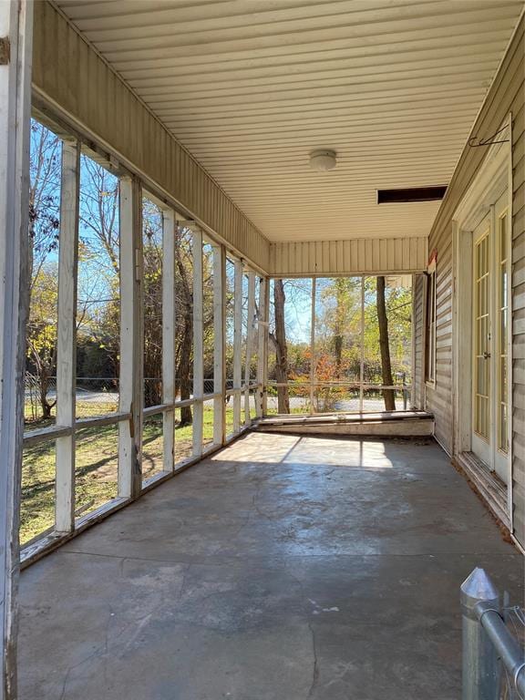 unfurnished sunroom with a wealth of natural light