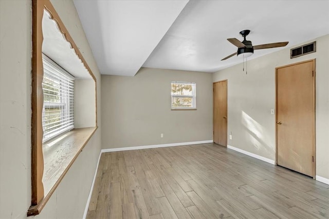 spare room with light hardwood / wood-style floors and ceiling fan