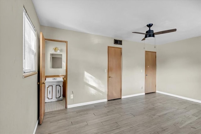 unfurnished room featuring ceiling fan, sink, and light hardwood / wood-style floors