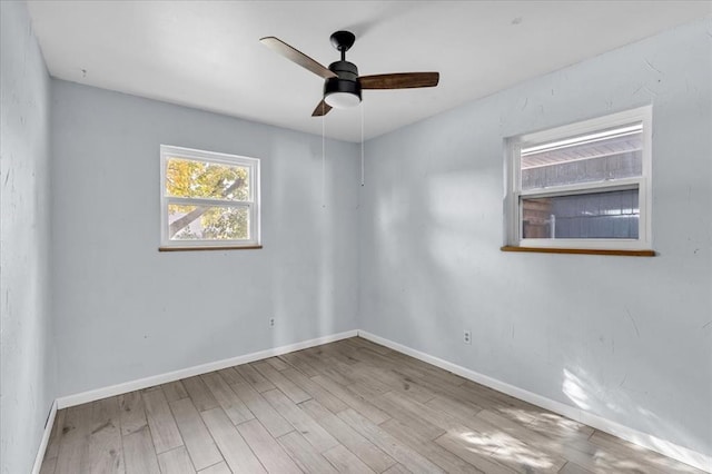 spare room with ceiling fan and light wood-type flooring