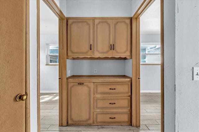 kitchen with light brown cabinets and light wood-type flooring