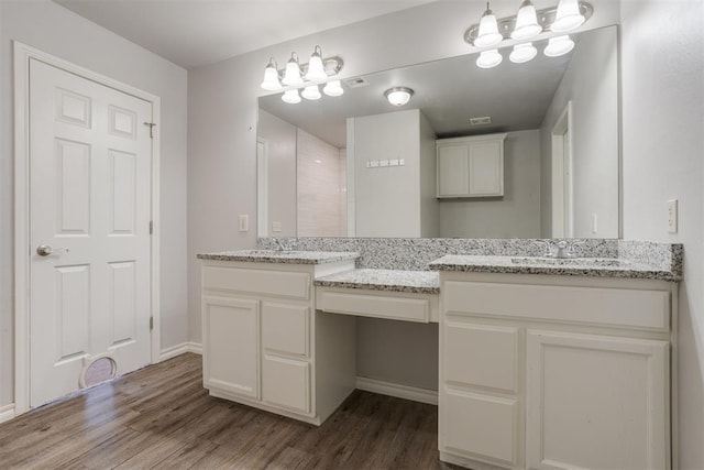 bathroom with hardwood / wood-style floors and vanity