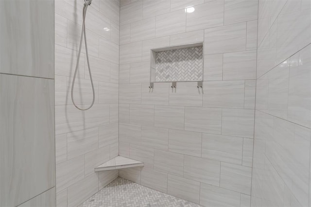 bathroom with tiled shower