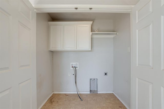 laundry area with electric dryer hookup, cabinets, light tile patterned floors, and washer hookup