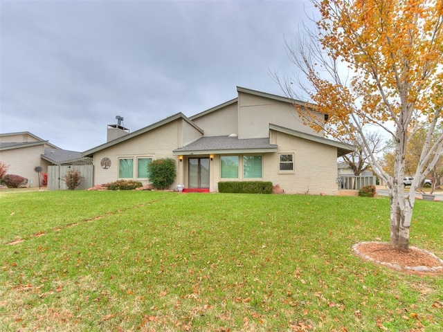 rear view of property with a lawn