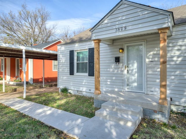 view of exterior entry featuring a carport