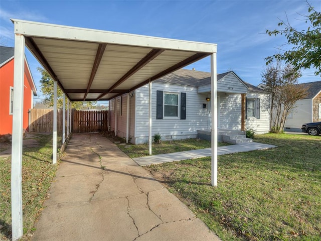 view of side of home with a carport and a yard