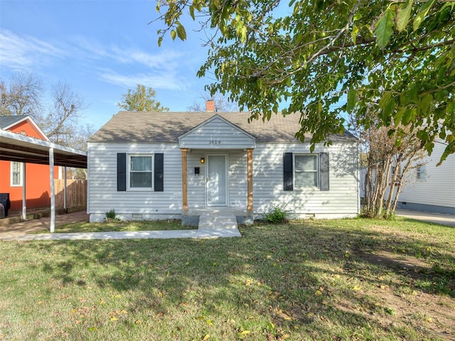 bungalow featuring a front lawn and a carport