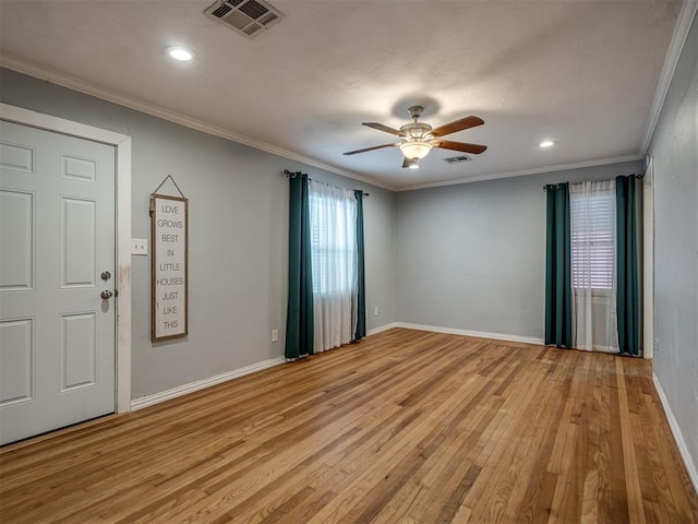 empty room with ceiling fan, light hardwood / wood-style floors, and ornamental molding