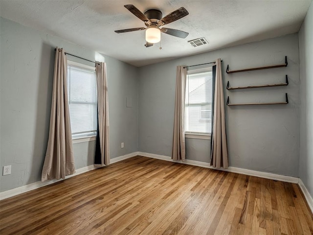 unfurnished room with ceiling fan and light hardwood / wood-style floors