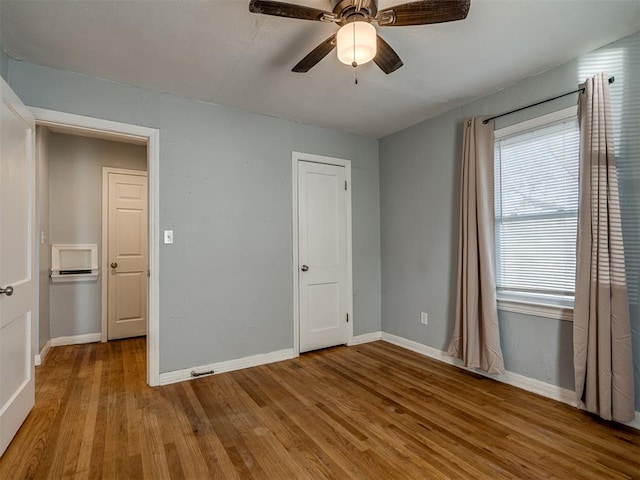 unfurnished bedroom with ceiling fan and light wood-type flooring