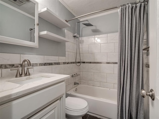 full bathroom with shower / bath combination with curtain, ornamental molding, vanity, tile walls, and toilet