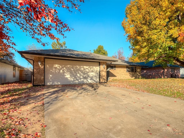 ranch-style house with a garage and a front lawn