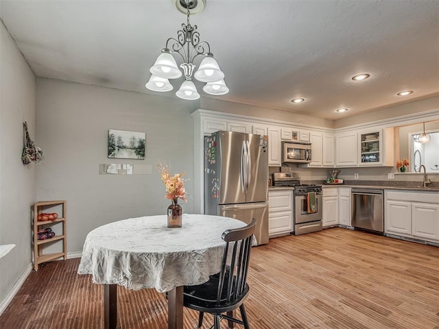 dining room featuring light hardwood / wood-style floors and an inviting chandelier