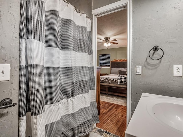 bathroom with hardwood / wood-style flooring, ceiling fan, and sink