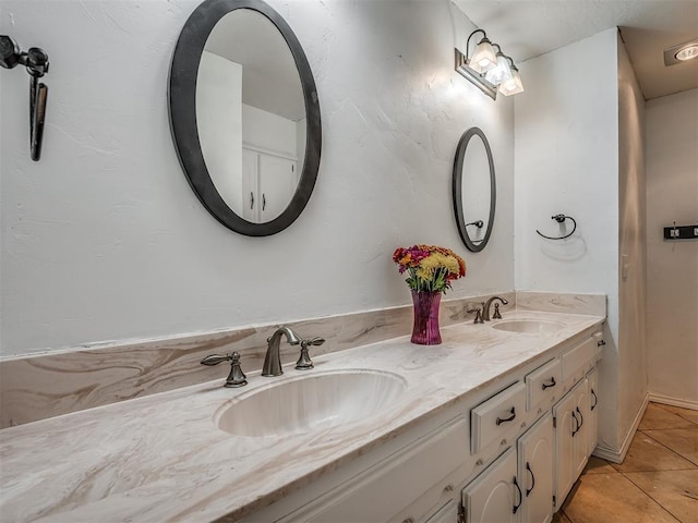 bathroom with tile patterned flooring and vanity