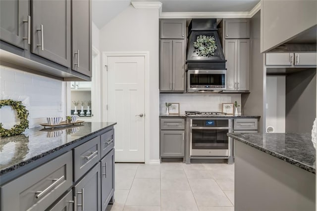 kitchen with tasteful backsplash, light tile patterned floors, stainless steel appliances, and gray cabinetry