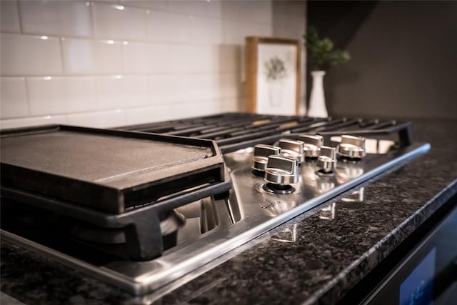 interior details with range and dark stone countertops