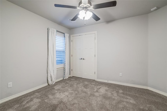 unfurnished room with ceiling fan and light colored carpet