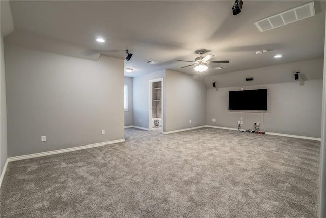 unfurnished living room with ceiling fan and carpet