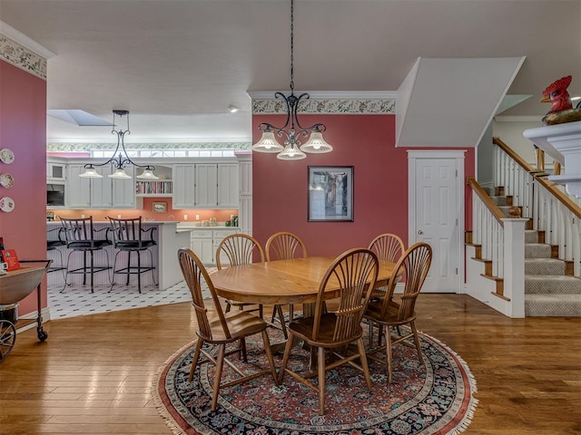 dining area with crown molding and wood-type flooring