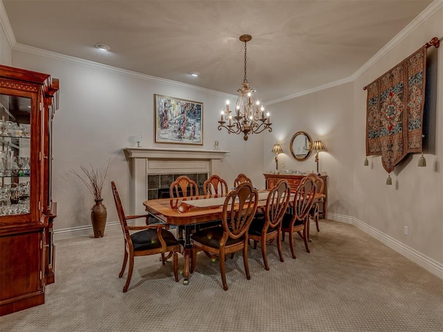 dining room with a tile fireplace, ornamental molding, and light carpet