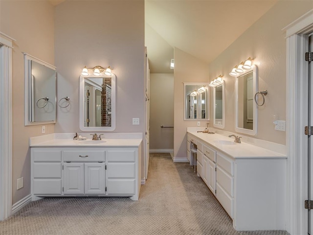 bathroom featuring vanity and vaulted ceiling