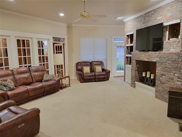 carpeted living room featuring a fireplace, ornamental molding, and ceiling fan